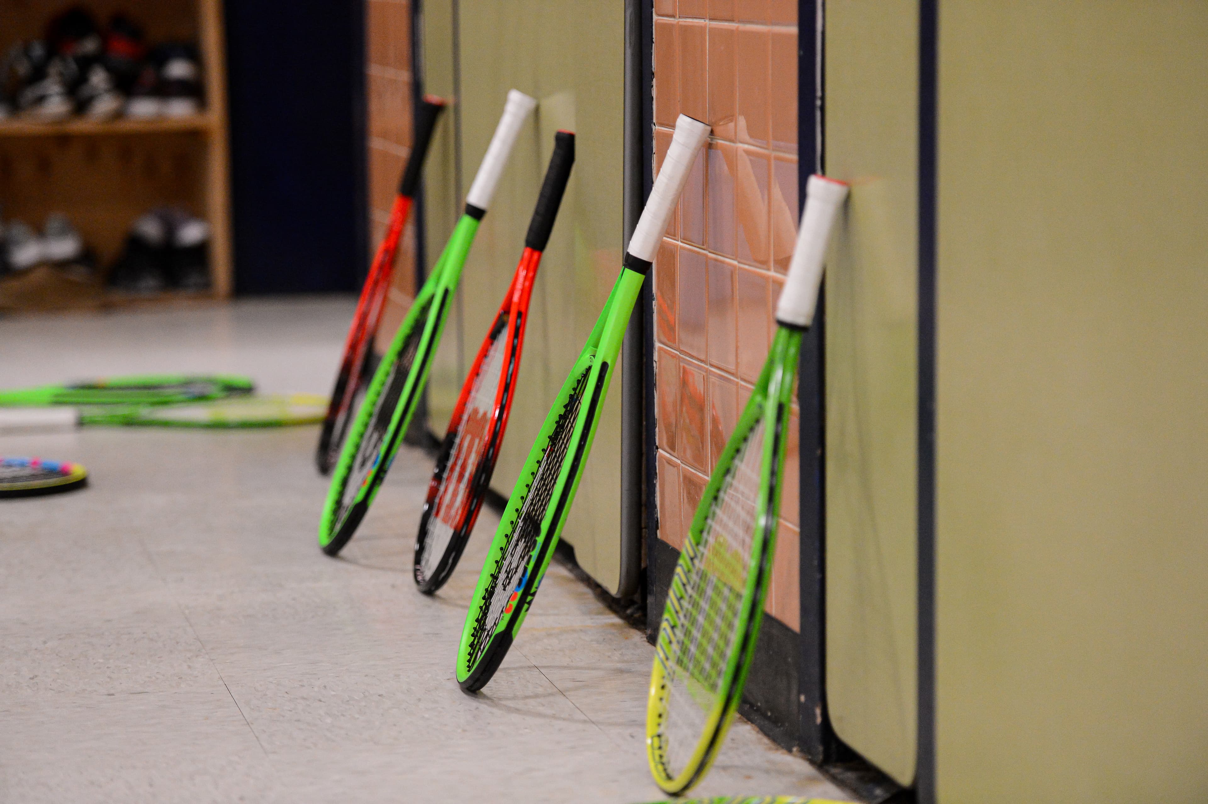 CourtBloom youth tennis photo — rackets in use